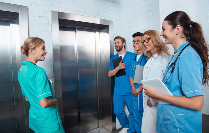 teacher-with-multicultural-students-waiting-elevat-2024-11-11-14-40-27-utc-1:667x424