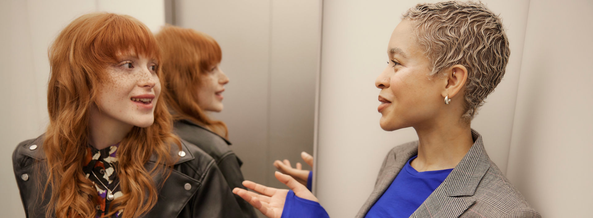 two-women-chatting-in-elevator-001:1920x705%28hero%29