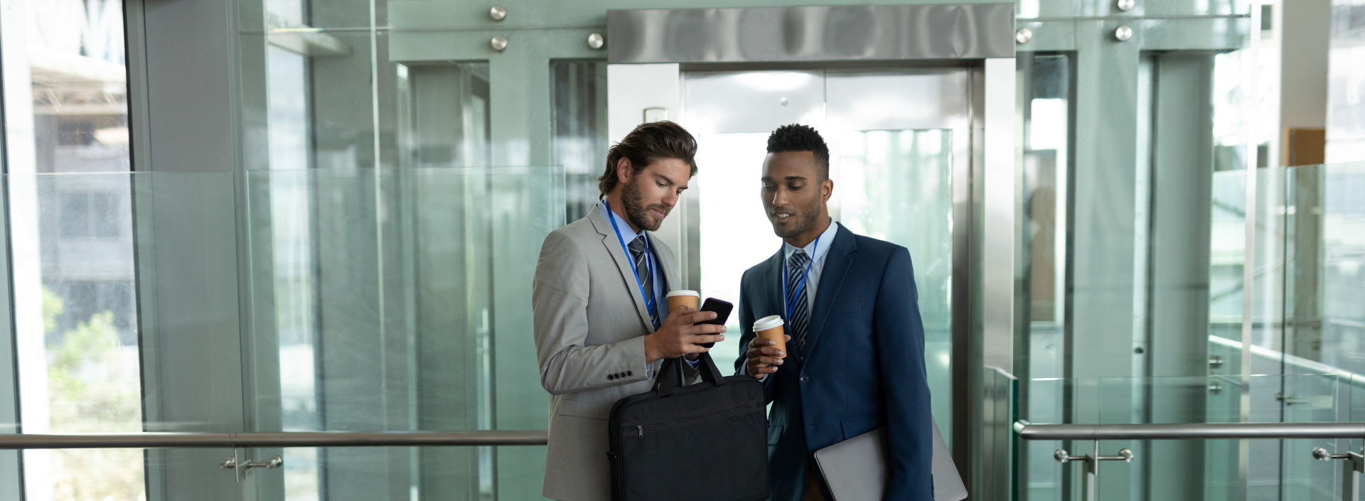 young-businessmen-discussing-over-mobile-phone-nea-2023-11-27-05-15-40-utc:1920x705%28hero%29