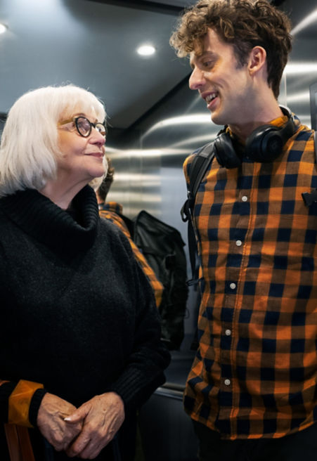 young_man_and_older_lady_in_residential_builings_elevator-1:451x656%2811-16%29
