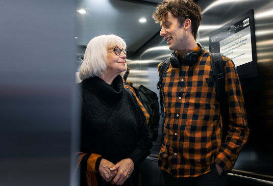 young_man_and_older_lady_in_residential_builings_elevator-1:535x365