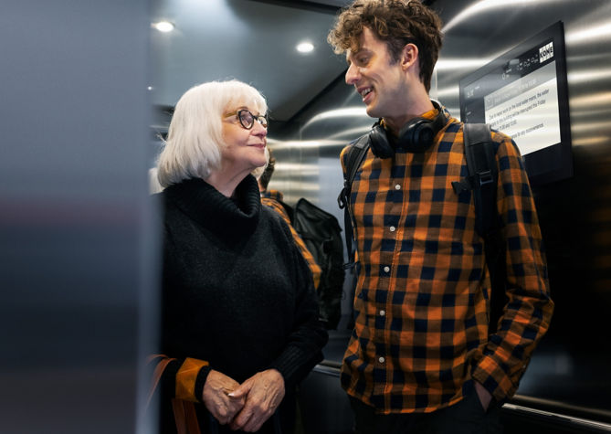 young_man_and_older_lady_in_residential_builings_elevator-1:669x475