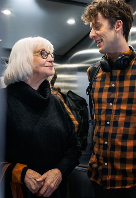 young_man_and_older_lady_in_residential_builings_elevator:451x656%2811-16%29