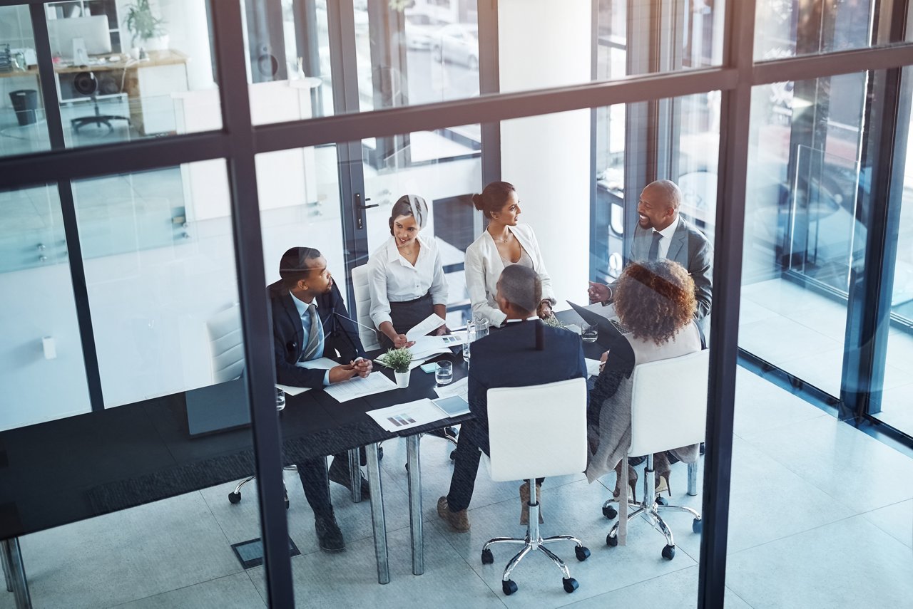 Collaboration, business meeting and team in discussion in the office for brainstorming or planning. Teamwork, company and group of corporate people working on project together in workplace boardroom