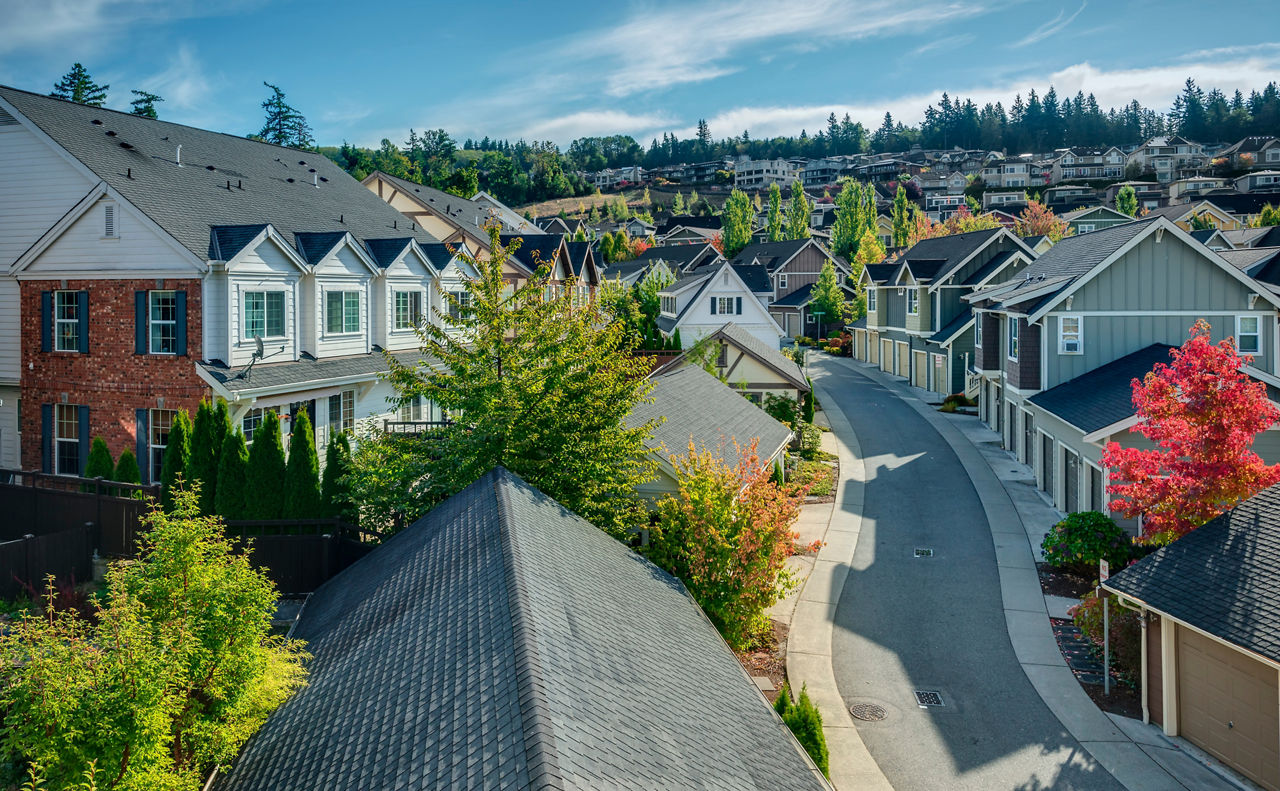 Houses line a Curvy Road that cuts through Residential Neighboorhoods in the Issaquah Highlands on an Autumn Morning