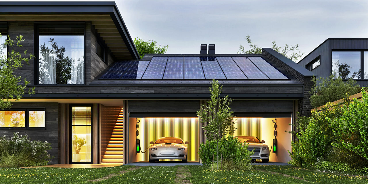 Evening view of a modern house with solar panels and electric cars