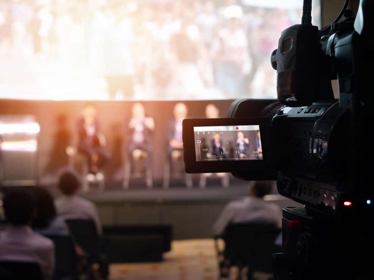 Video Presentation media and live streaming record and broadcast in real time for social network concept. VDO camera taking live video streaming at seminar technology event with flare light effect.