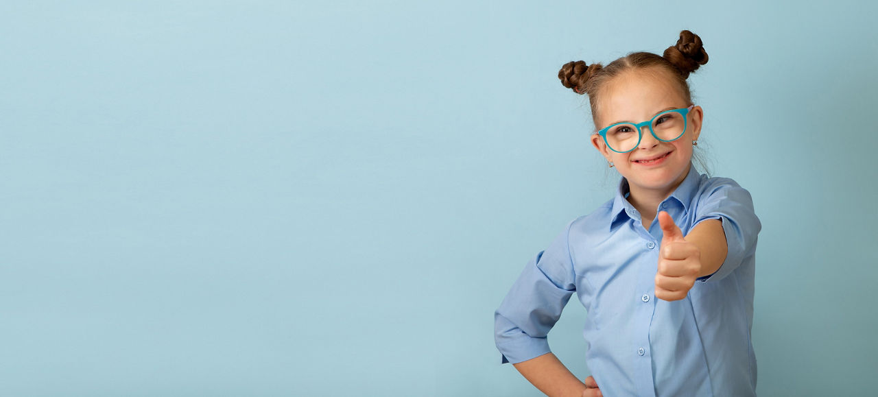 Happy girl with Down syndrome having fun and laughing in the studio. Banner