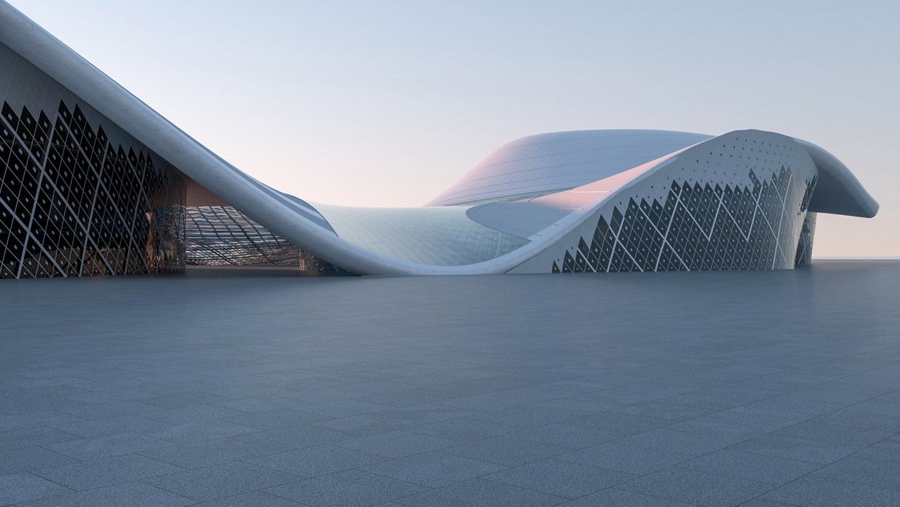 Large white curved building with patterned exterior in a wide open paved space.