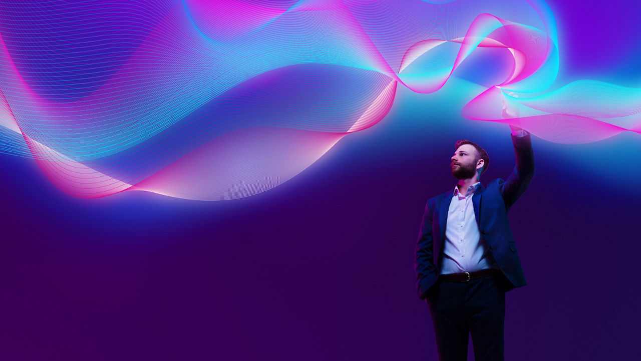 Person reaching towards flowing abstract light patterns against a dark purple background.