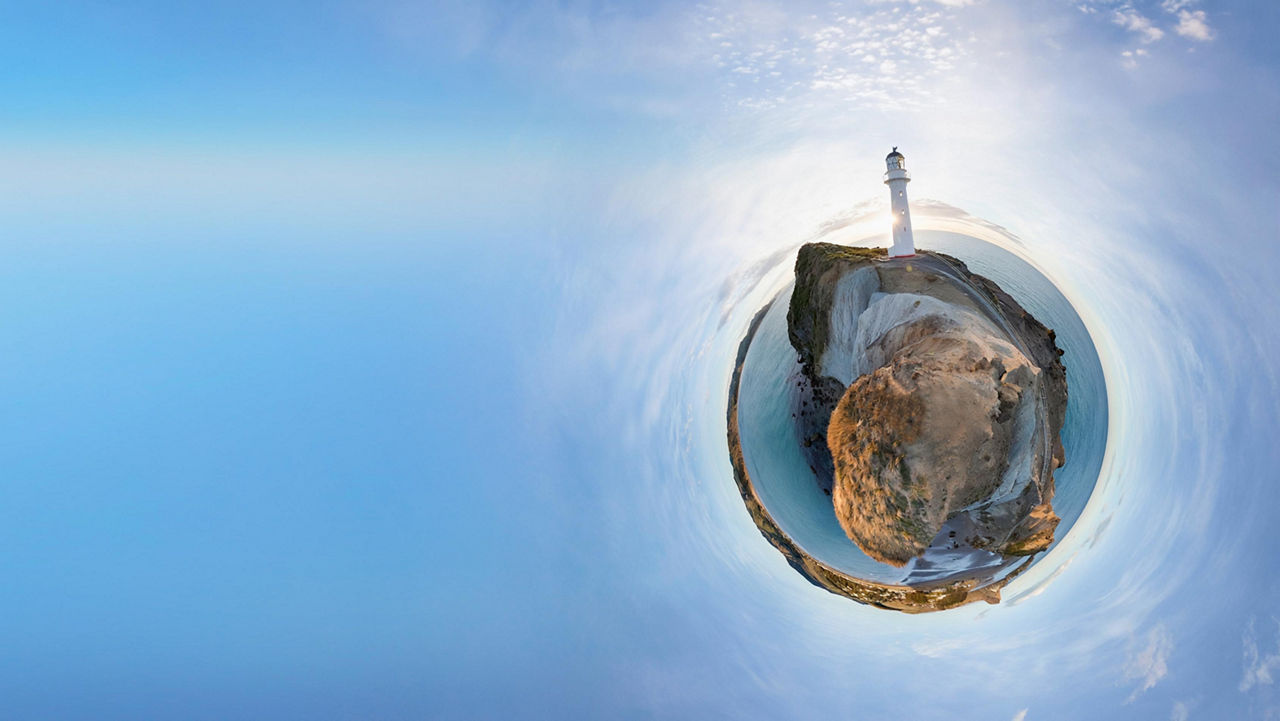Panoramic spherical view of a lighthouse on a rocky coastal headland.
