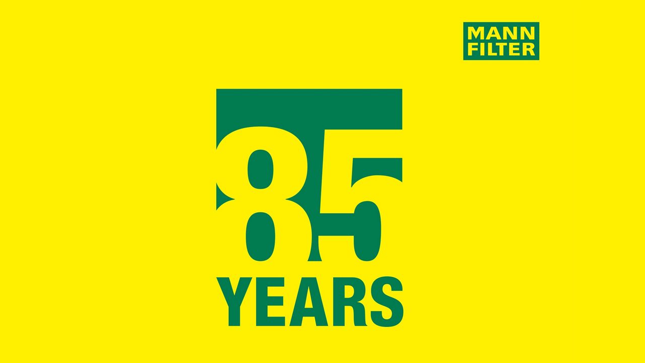 85 years anniversary signe with MANN-FILTER logo on the top left on a yellow background 