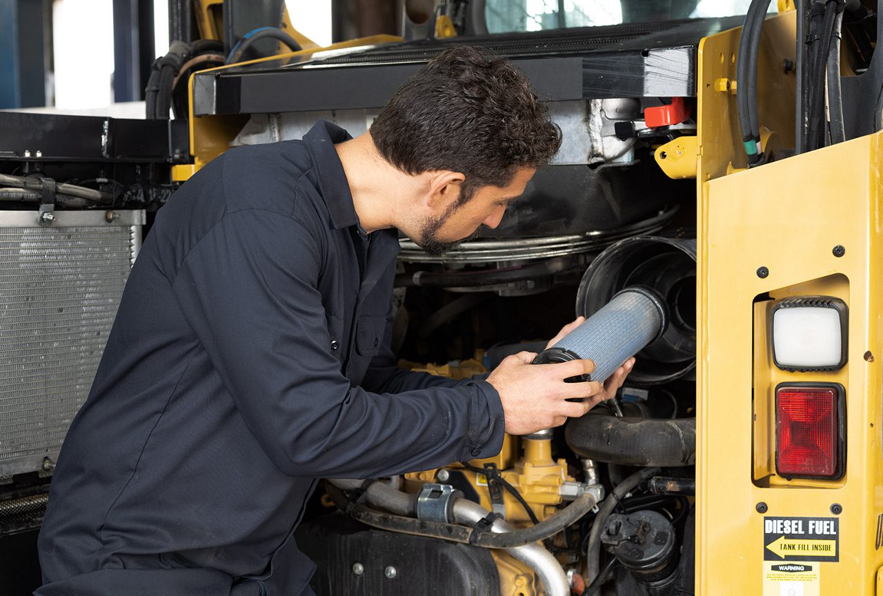 Mechanic changing an oil filter