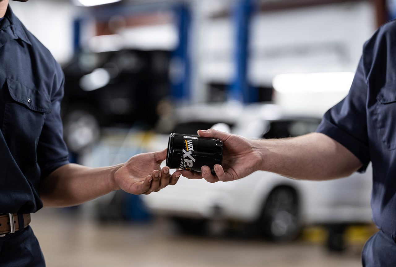 Auto mechanic replacing a cabin air filter