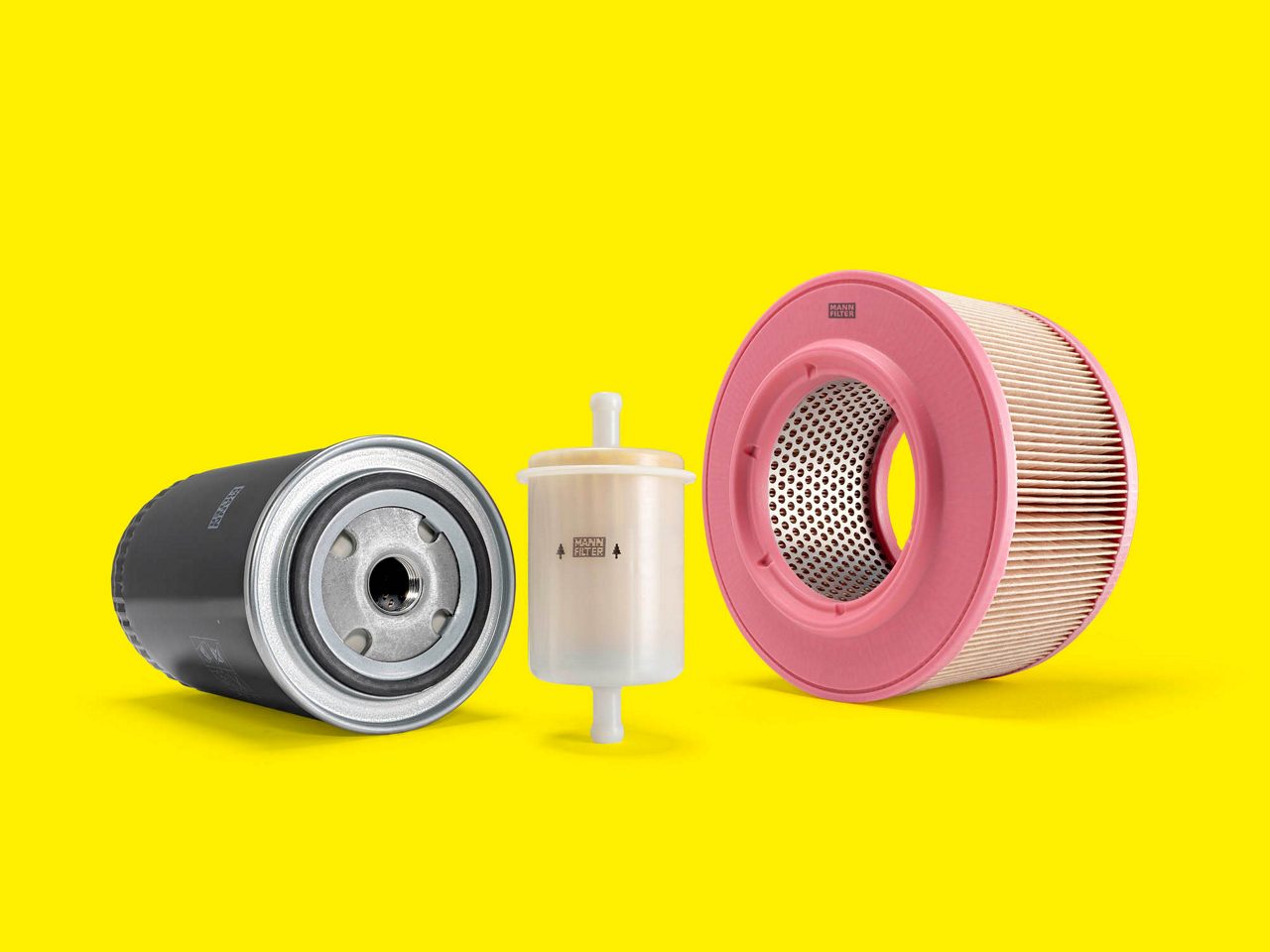 A selection of genset filters, including air and fuel filters, displayed on a yellow background