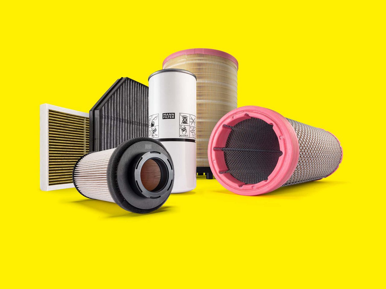 MANN-FILTER truck and bus filters, including air and cabin filters, displayed on a yellow background