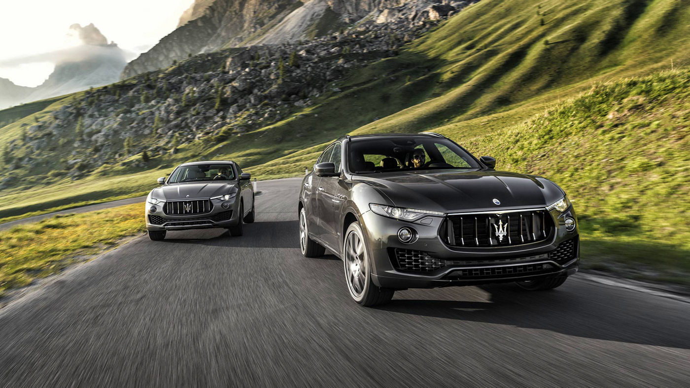 Two Maserati Levante on the road - Grey models front view