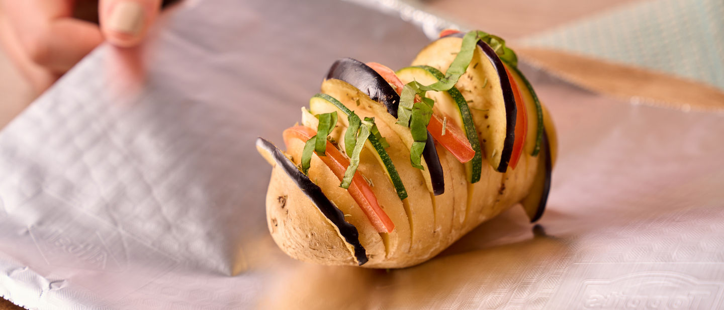 Ofenkartoffel mit Gemüse und Kräutern auf Toppits Alufolie vorbereitet.