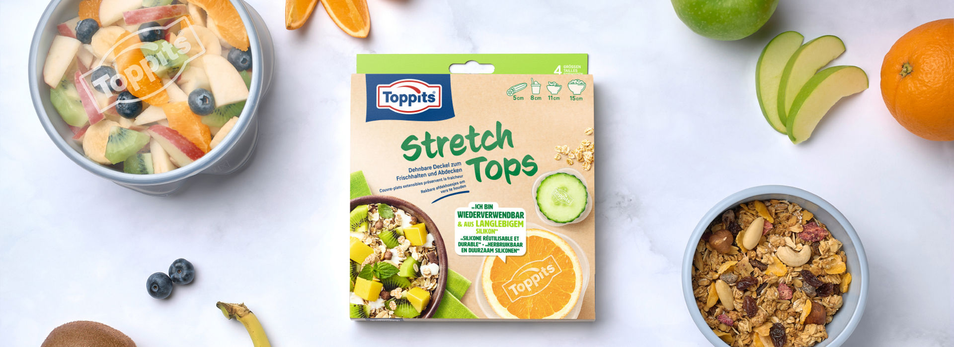 Emballage Toppits® Stretch Tops entouré de différents aliments.