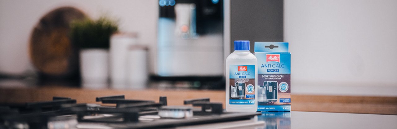 Melitta® Descaler FAM Product next to stove