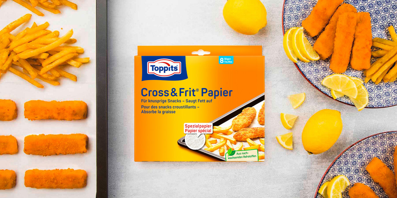 Toppits Cross & Frit Papier mit knusprigen Pommes und Fischstäbchen auf einem Backblech.