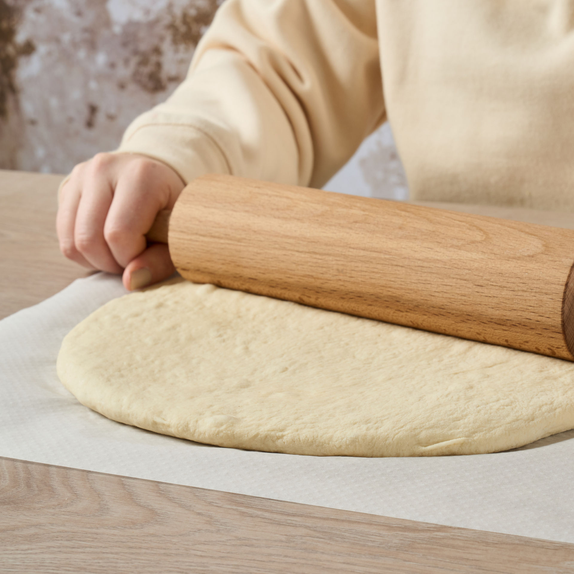 Pâte étalée sur du papier cuisson Albal® avec un rouleau à pâtisserie