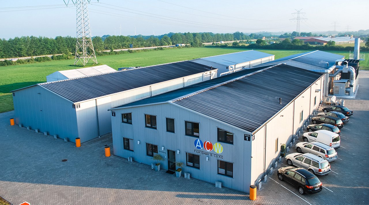 Two industrial buildings in grey with flat Sattelnbach with ACW logo.