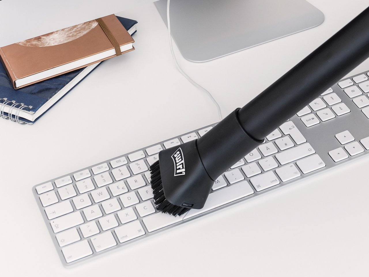 Computer-Tastatur wird mit Swirl Abstaubdüse gesaugt