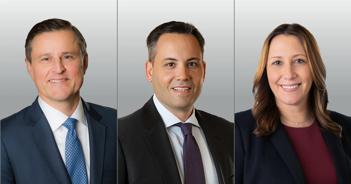 Professional corporate headshots of three executives