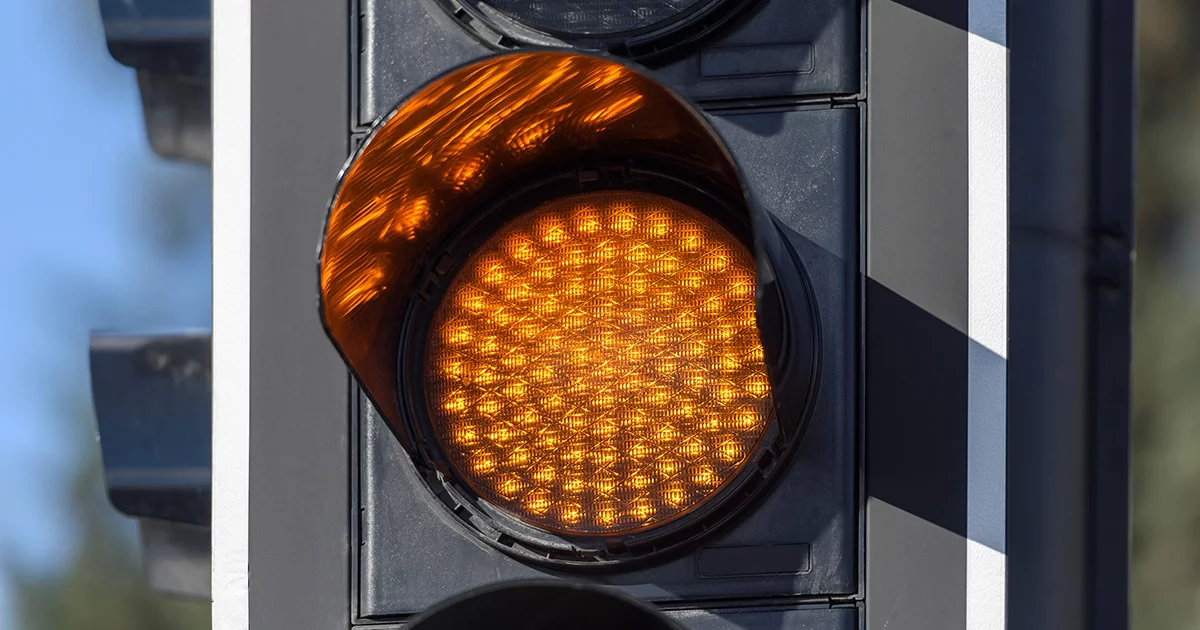 Close-up of a yellow traffic light.