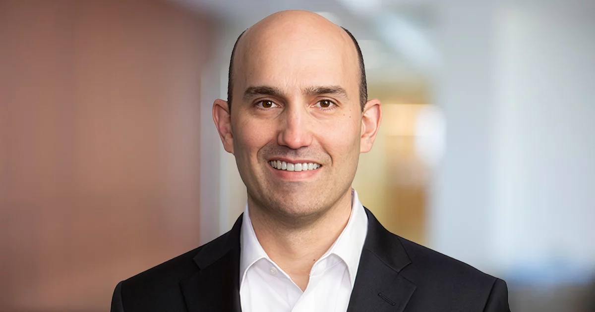 Smiling bald businessman in office corridor