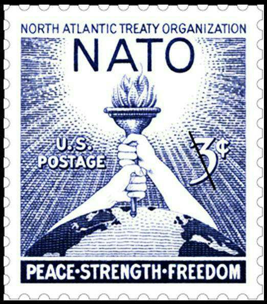 1952 American NATO stamp showing two hands holding a torch above a globe