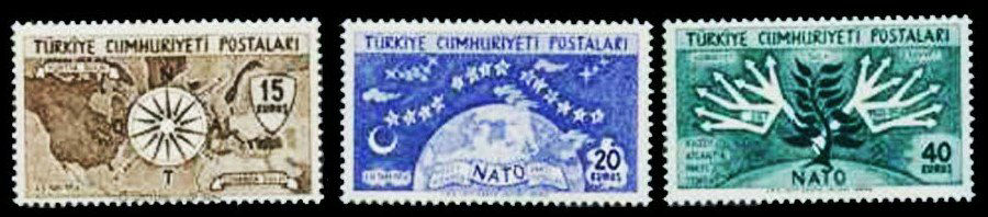 1954 Turkish NATO stamps depicting a compass and a map of the Northern Hemisphere (left); a crescent moon and 14 stars over the globe, representing the 14 NATO Allies at that time (centre); and a tree with 14 branches (right).