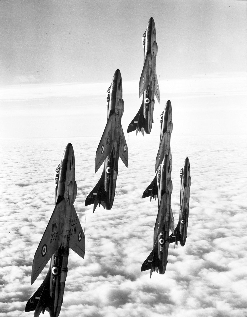 Fighter jets perform a vertical climb during a NATO air exhibition.