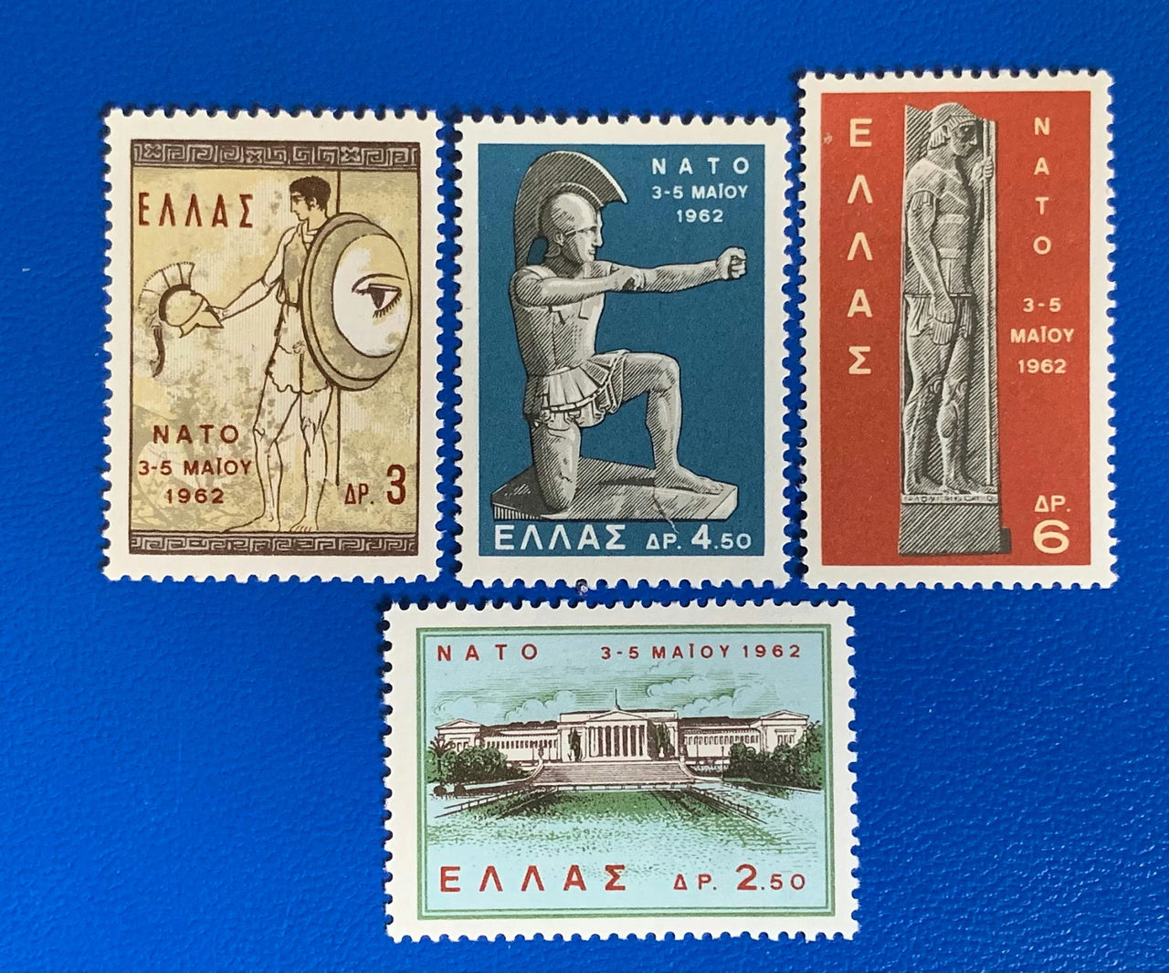 1962 Greek NATO stamp, depicting Ancient Greek warriors in various poses and the Greek Parliament