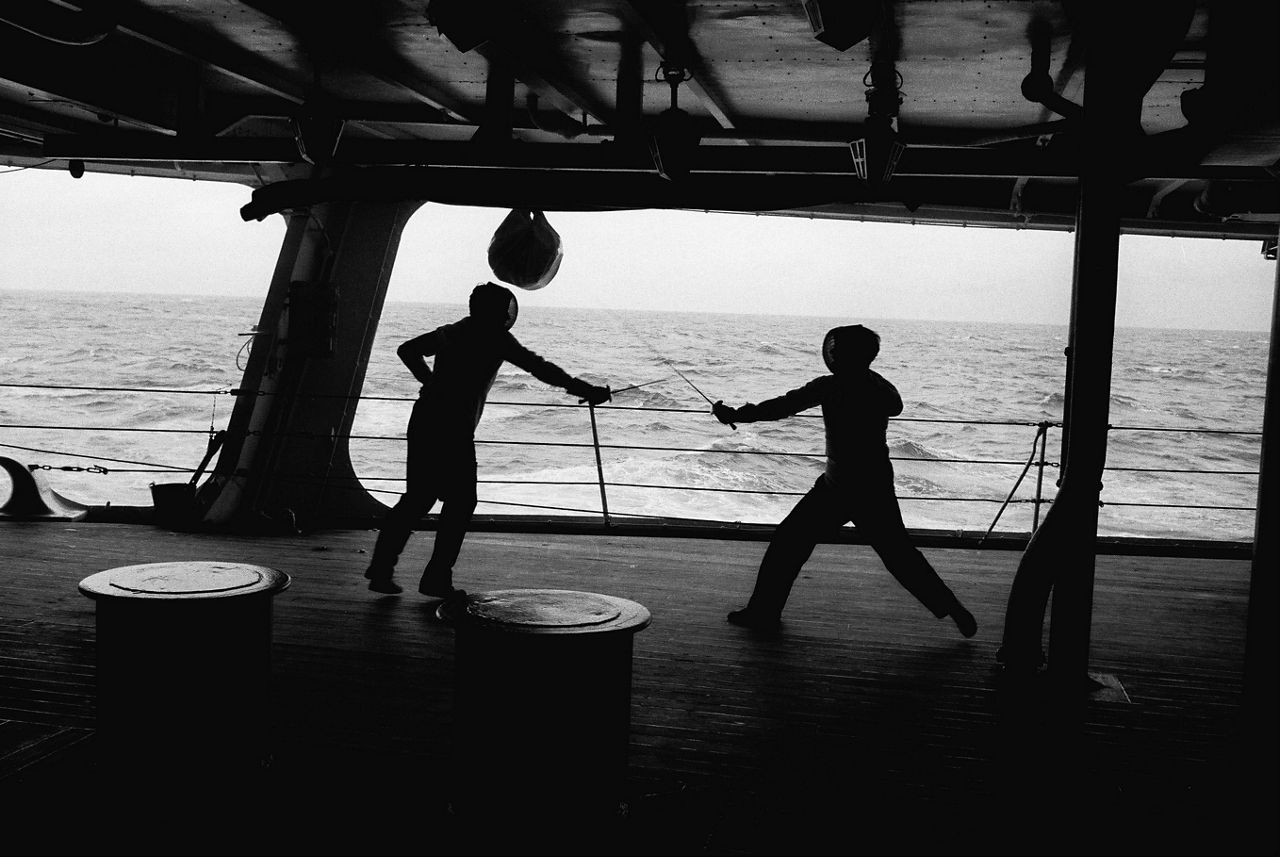 Sailors fence with each other on a ship anchored in the Gulf of Naples during exercise Silver Tower, a NATO naval exercise in September 1968.