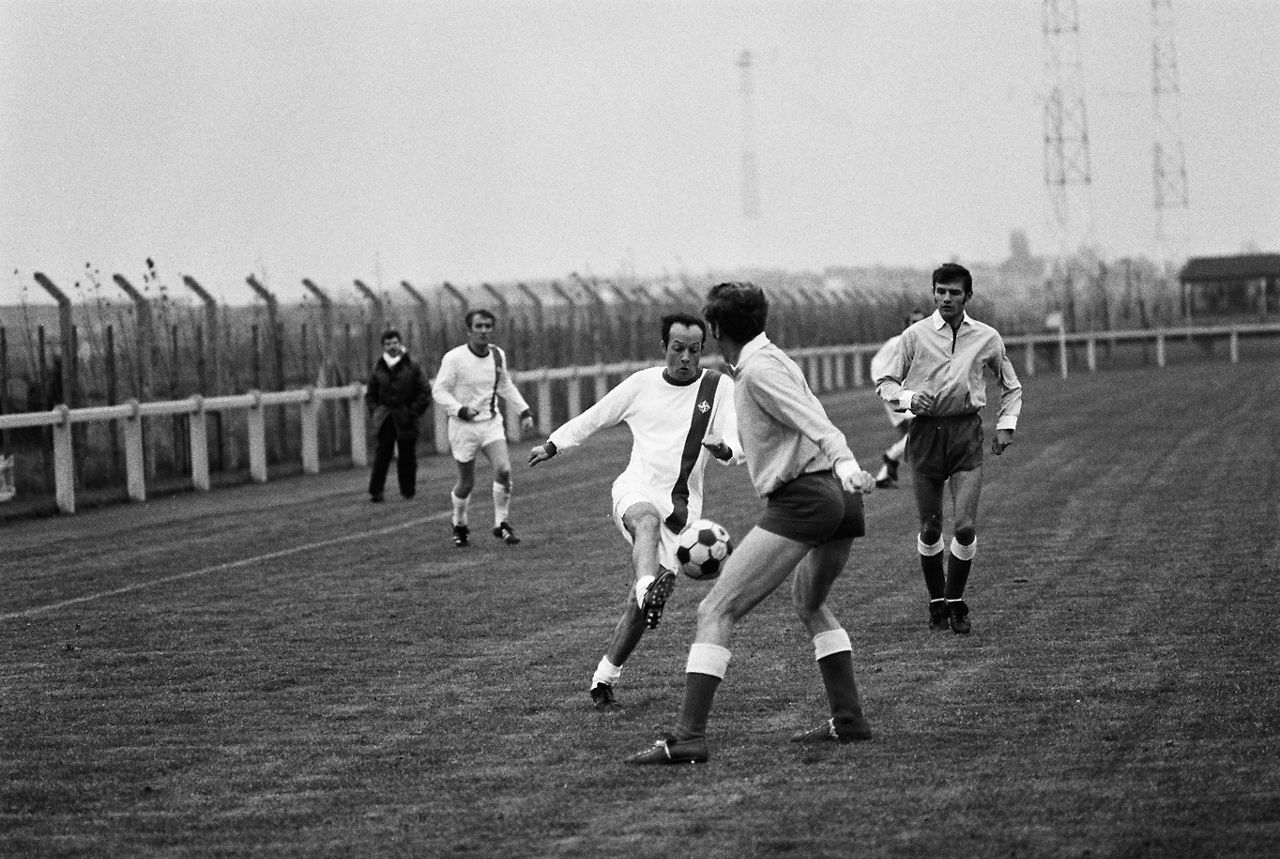 A football player with a NATO logo on his jersey tries to get past his opponent during a friendly match at the opening of the NATO Staff Centre at NATO Headquarters in Brussels, Belgium in November 1973.