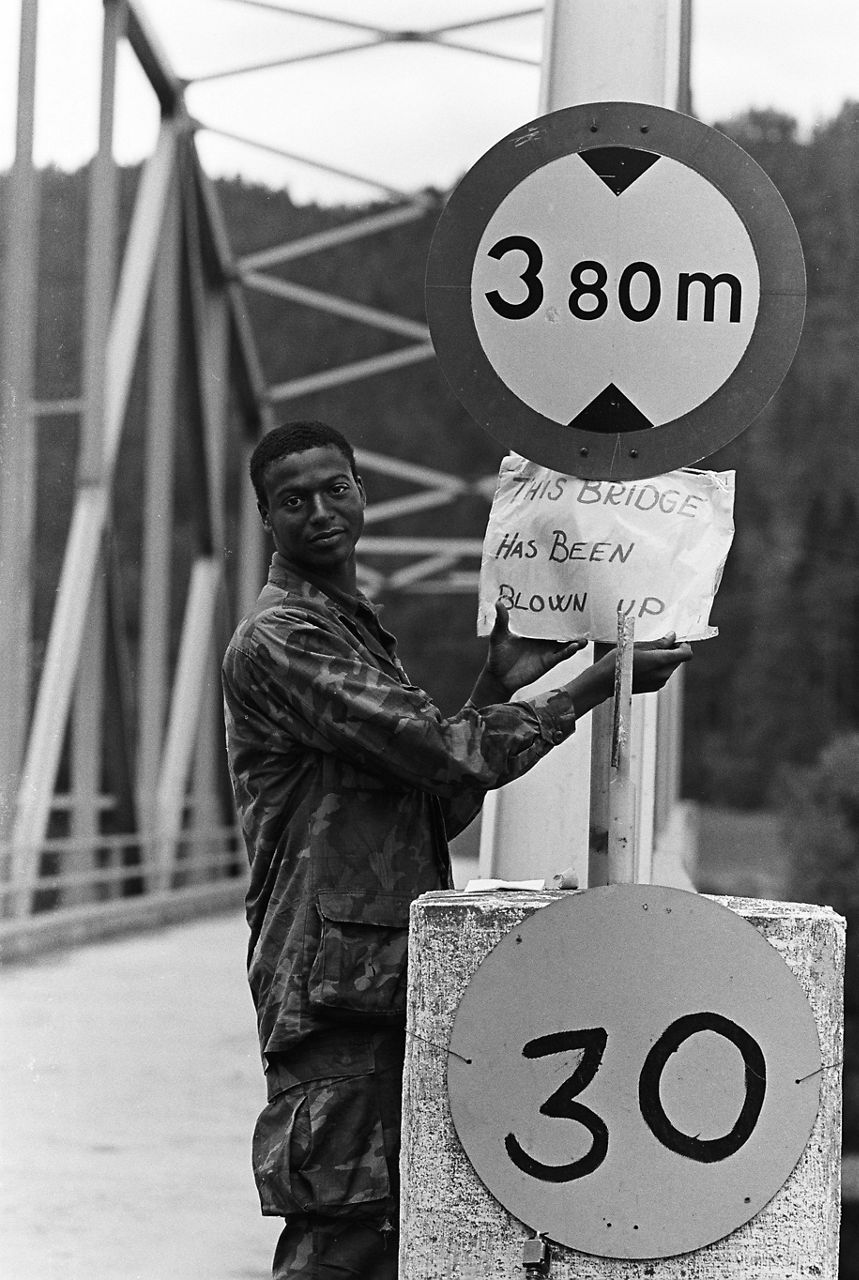 A soldier holds up a sign reading “This bridge has been blown up” during exercise Teamwork in Norway in September 1980