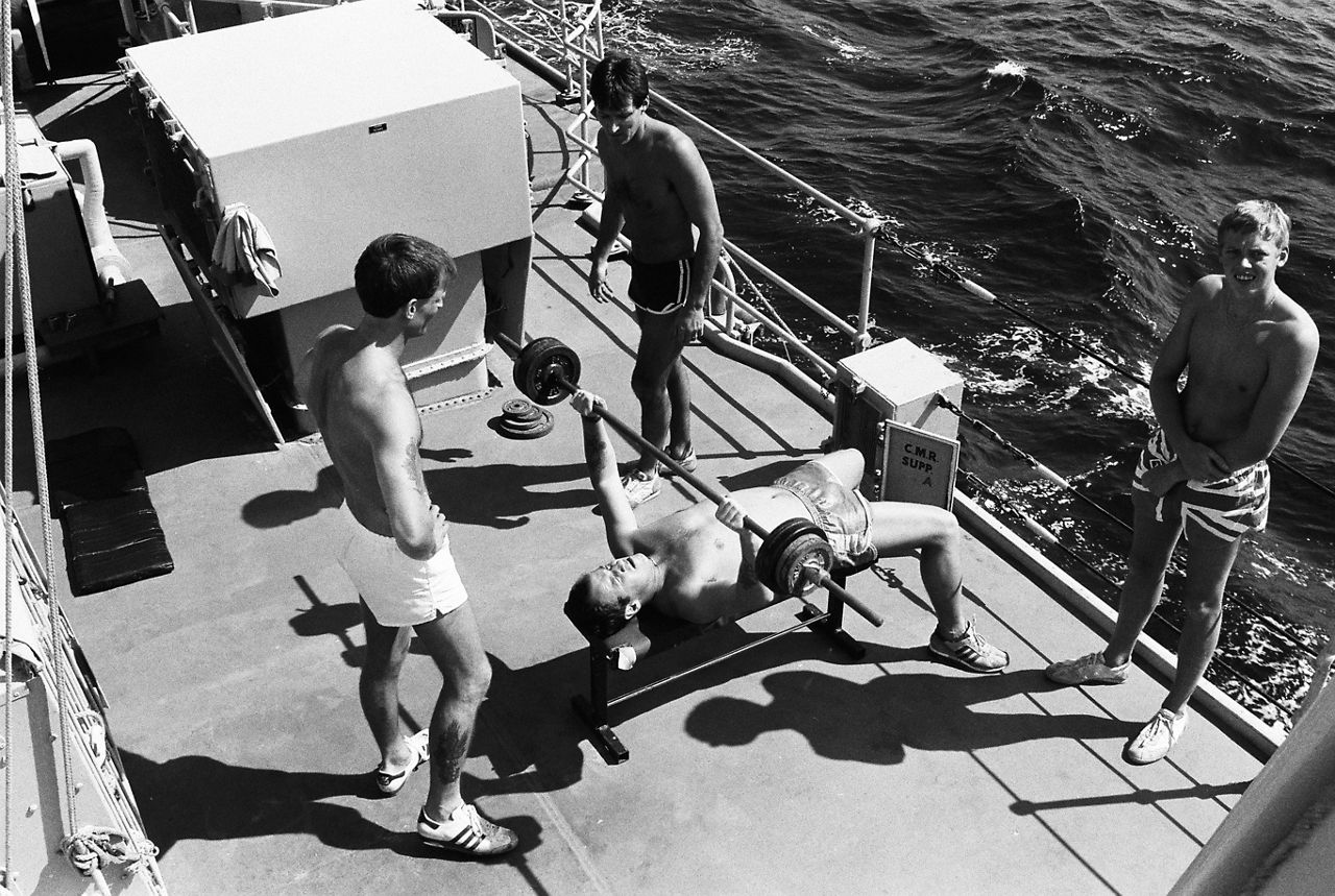 Sailors pump iron on deck during exercise Open Gate in the sunny Mediterranean Sea.