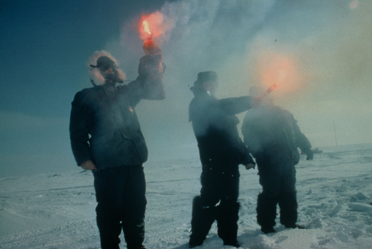 Soldiers hold up flares to indicate a landing zone during a joint exercise between the United States and Russia after the end of the Cold War. 