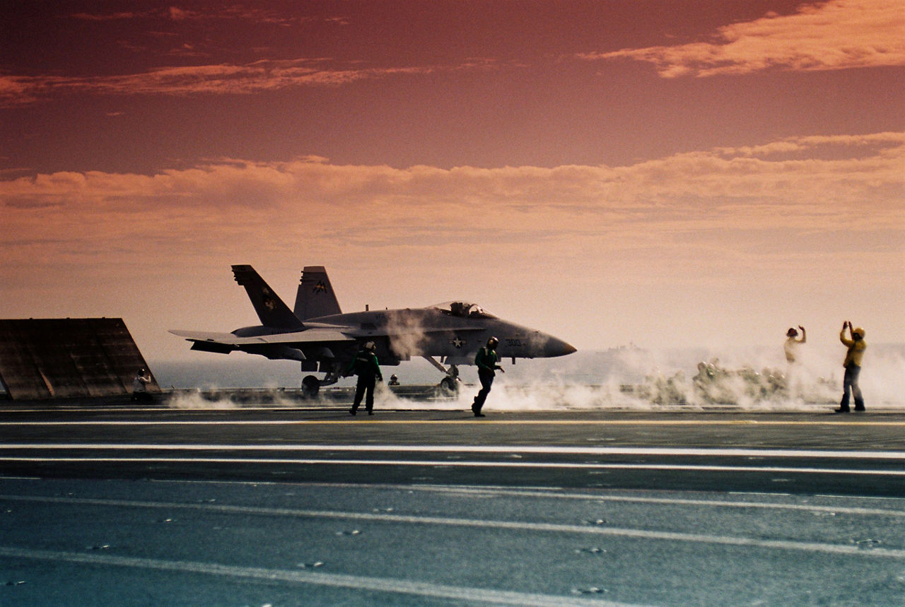 A fighter jet prepares to take off from the deck of an aircraft carrier during a meeting of NATO defence ministers in Williamsburg, United States. 