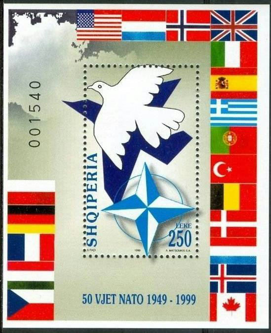 1999 Albanian NATO stamp, with a dove of peace casting the shadow of a fighter jet, surrounded by Allied flags
