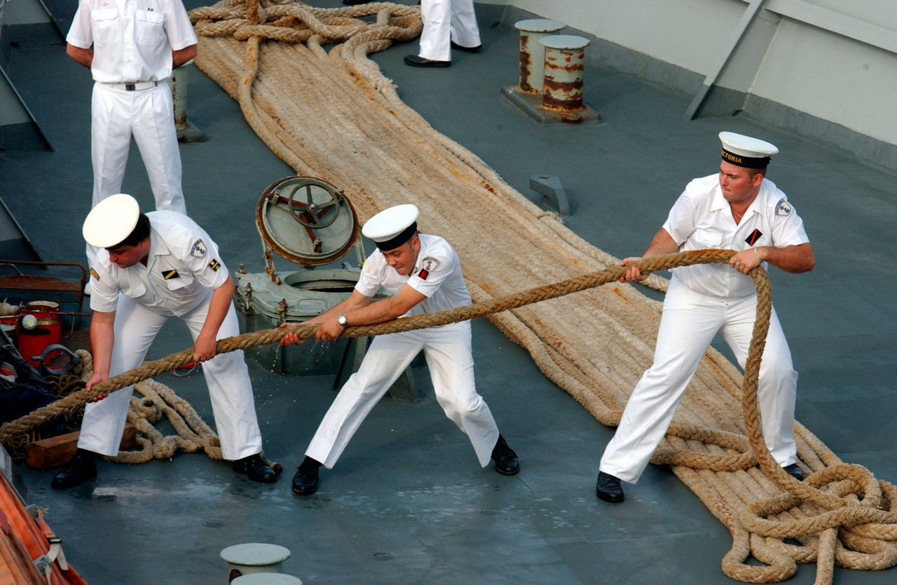 Sailors heave on a rope during a visit of the North Atlantic Council to Alicante, Spain in June 2003.