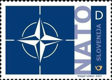 2004 Slovenian NATO stamp, a simple dark blue design with the NATO compass logo