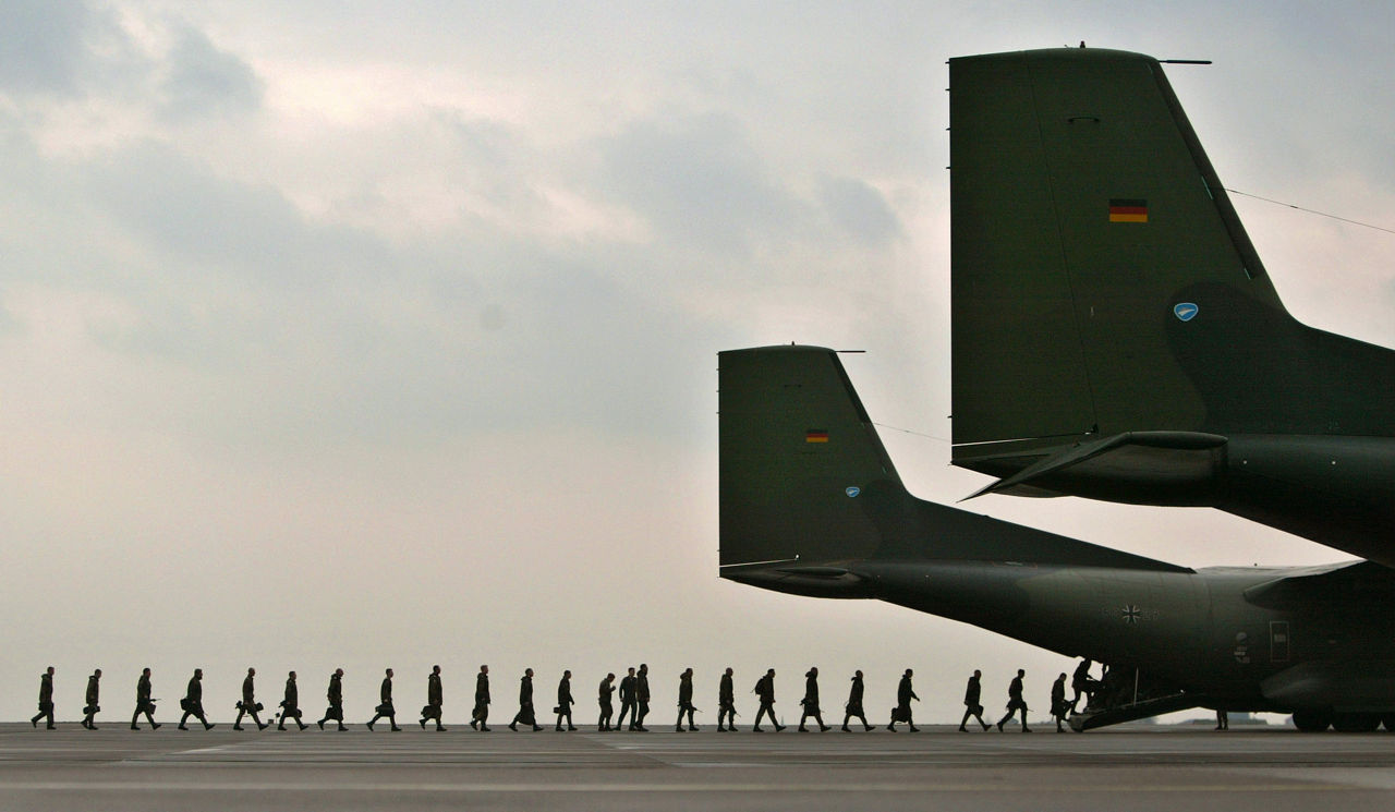 Soldiers board a transport plane to Kosovo in March 2004. 