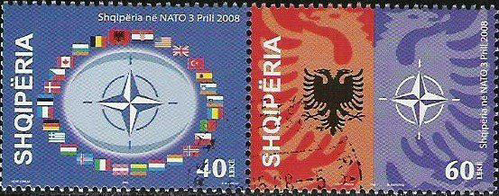 2009 Albanian NATO stamp, showing the Albanian coat of arms and the NATO logo, along with Allied national flags