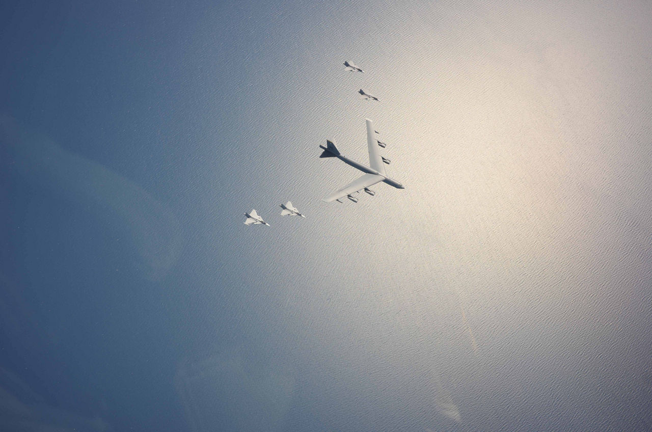 A bomber and four accompanying fighter jets fly over the Baltic Sea during exercise Baltic Operations (BALTOPS) 2015. (Photo credit: United States Air Force/Swedish Armed Forces.)