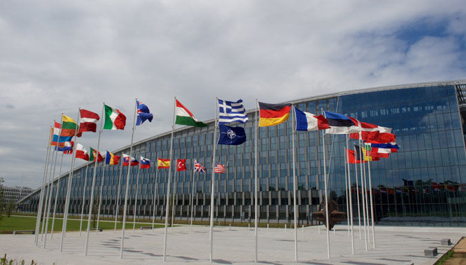 Exterior view of the new NATO Headquarters with NATO's and the 29 member nations' flags