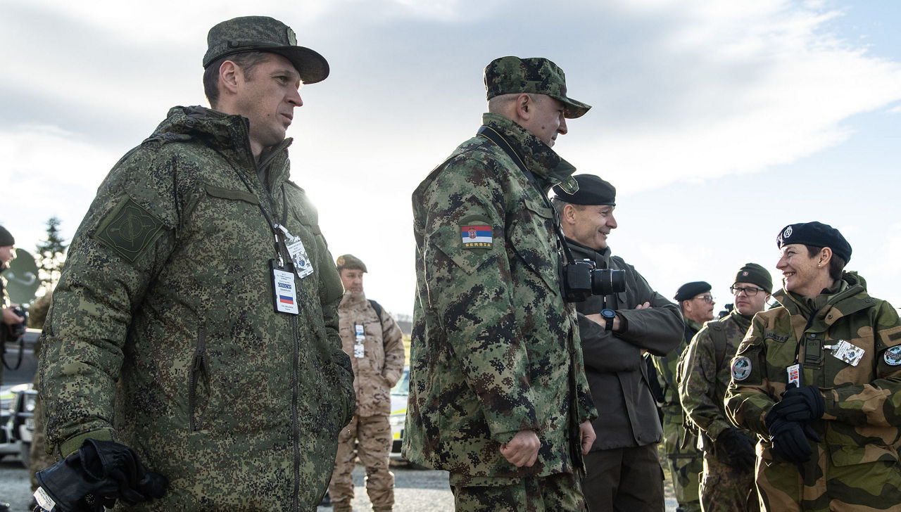 Military observers with the Russian Federation, left, and Serbia, center, watch a demonstration during Exercise Trident Juncutre 2018. Both Russia and Serbia are members of the Organization for Security and Cooperation in Europe, and they observed Trident Juncture at the invitation of NATO.