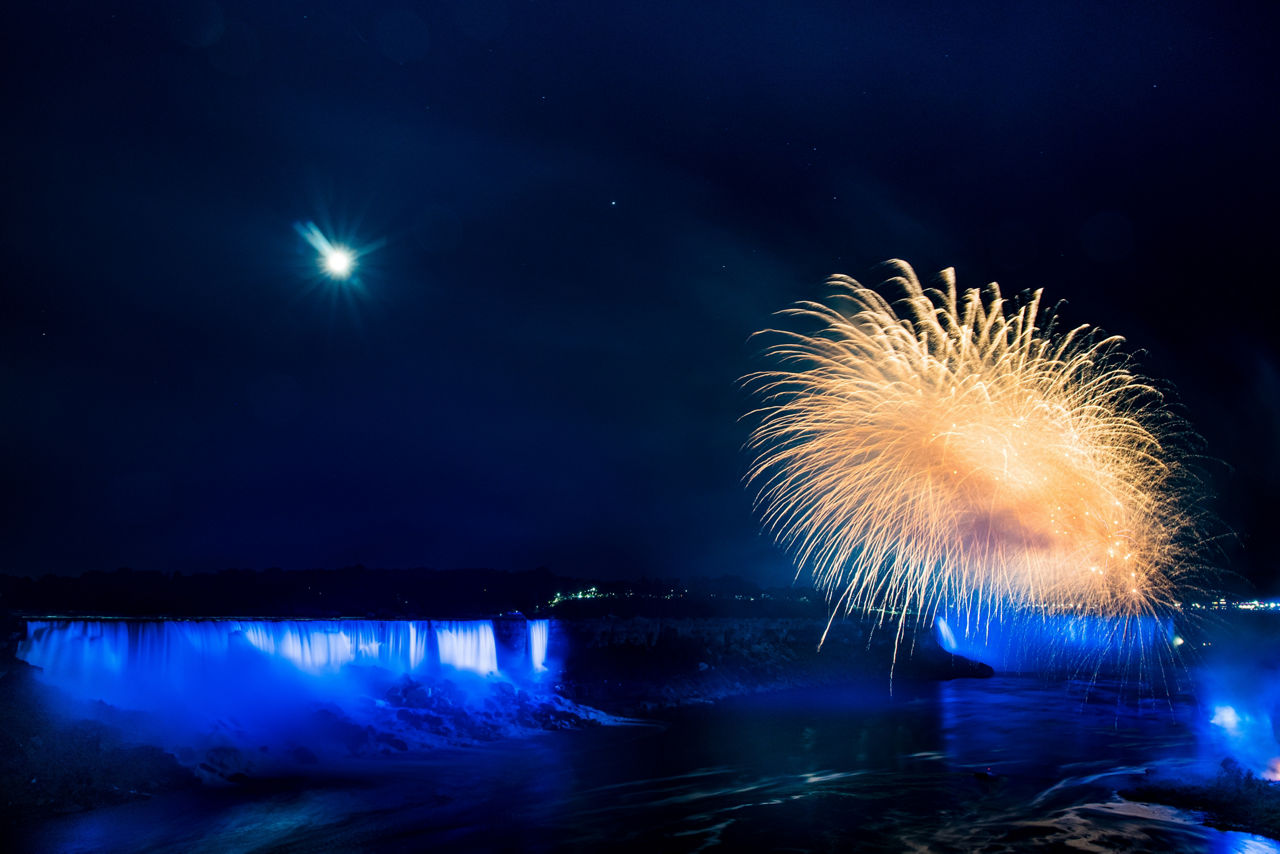 Fireworks erupt over Niagara Falls, which have been lit up in NATO blue to mark the Alliance’s 70th anniversary in 2019.